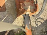 an old rusted gas can with a hose attached to it