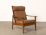 the chair is made of wood and has a brown upholstered seat