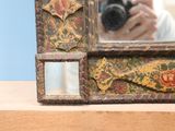 someone taking a picture of a mirror with a camera in front of it