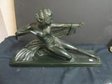 bronze statue of a woman holding a sword on a blue cloth