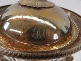 a silver plate with a dome on top of it