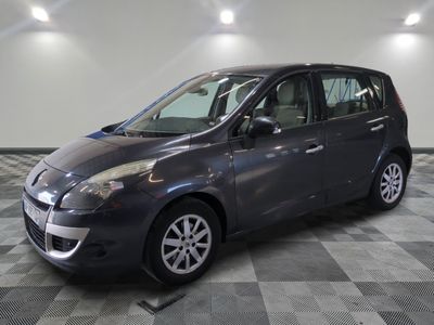 a picture of a grey car parked in a garage