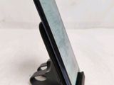 a cell phone that is on a stand on the table