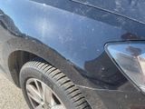 a close up of a car ' s headlight and the front end of the car