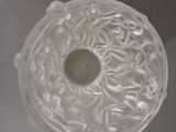 a clear glass bowl with a small amount of liquid in it