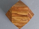 a wooden diamond shaped object hanging on the wall