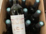 bottles of wine are in a cardboard box on a table
