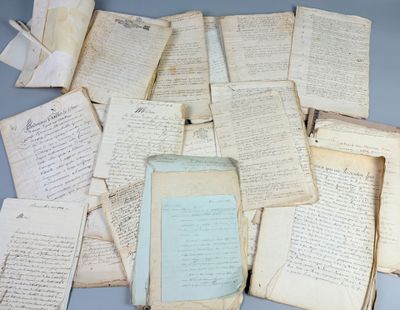 a lot of old papers and a bottle on the table