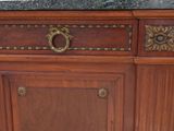 a close up of a wooden cabinet with a marble top