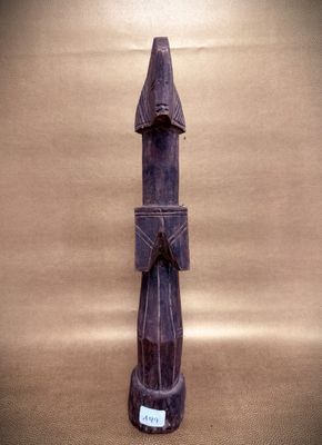a wooden statue of a man with a hat on