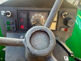 a close up view of the dashboard of a green tractor