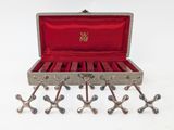 a wooden box with a bunch of metal objects inside of it