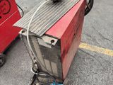 a red machine that is sitting in the parking lot