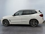 the bmw x3 is parked in a showroom with a white background