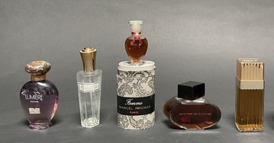 several different types of perfume bottles are lined up on a table