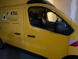 a yellow van parked in a garage with a ladder on the roof