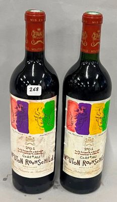 two bottles of red wine sitting next to each other on a table