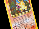 a yellow pokemon card with a picture of a dragon on it