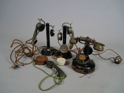 many different types of telephones and cords on the table