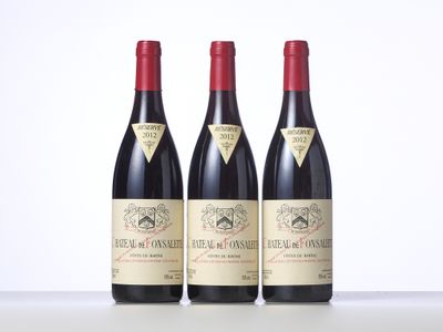 three bottles of wine are lined up on a table