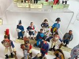 a lot of figurines that are on display in a case