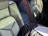 the back seats of a car are covered with a blanket