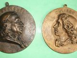 two bronze medallions of a man and a woman
