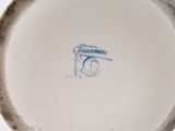 a white plate with a blue and black design on it
