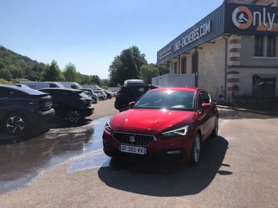 a red car that is parked in front of a building