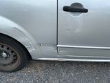 a small silver car that is parked in a parking lot