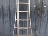 a ladder that is leaning against a metal wall