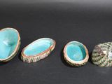 four different types of ceramic bowls sitting on a black surface