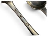 a spoon and a spoon rest on a white surface