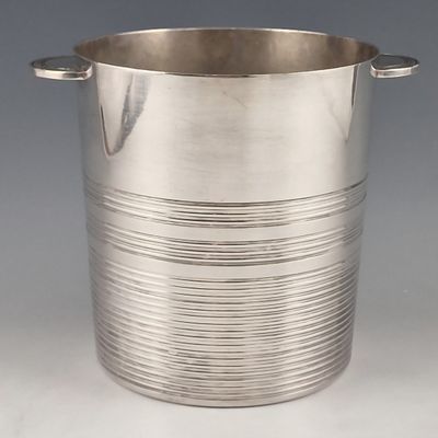 silver plated ice bucket with handles and handles on a grey background