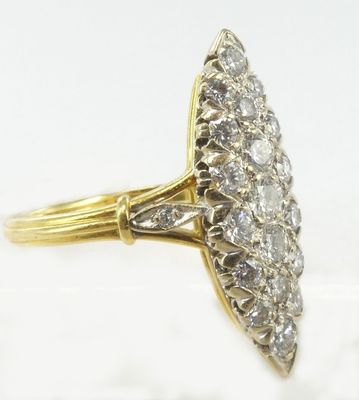 a close up of a diamond ring on a white surface