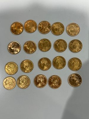 a lot of gold coins that are on the table