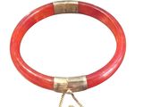an image of a red bracelet with a gold clasp on a white background