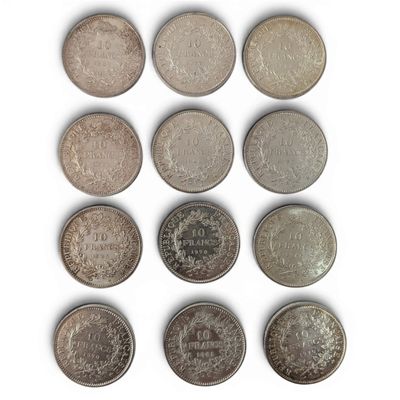 six different british coins are arranged in a row on a white surface