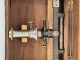 a wooden box that has a small machine inside of it