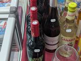 many bottles of wine and glasses on the table