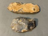 two rocks that are sitting on a table next to each other
