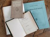 three books are sitting on a wooden table next to each other