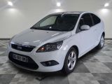 a picture of a white car parked in a garage