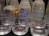 bottles and glasses are lined up next to each other on a table