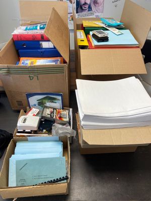 many boxes of books and papers on the table