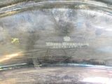 a close up of a silver plate with a logo on it