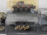 many different models of military vehicles on display in a case