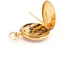 a gold pocket watch with a gold chain on a white background
