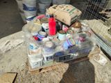 a box full of cans sitting on the ground next to a bird cage