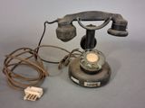an old telephone with a cord attached to it